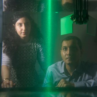 Dr Soudeh Mazharmanesh and Dr Sridhar Ravi from the University of NSW Canberra watch illuminated particles flow through a tank while testing a wing shape. The app work examines how insects can give insights into drone engineering.